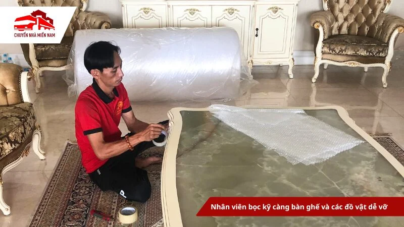 Nhân viên bọc kỹ càng bàn ghế và các đồ vật dễ vỡ